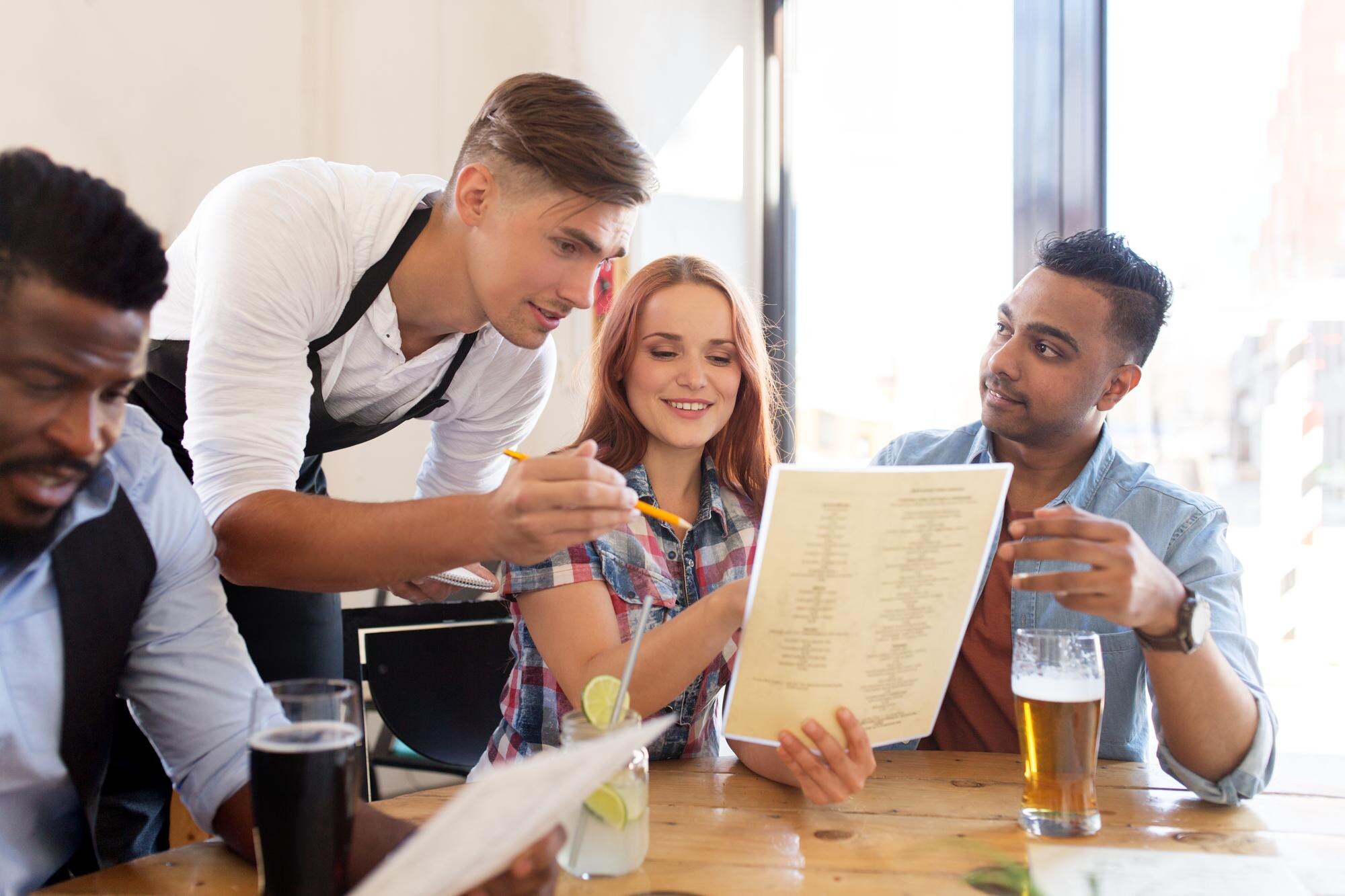 service people concept group happy international friends with menu drinks waiter with notepad receiv