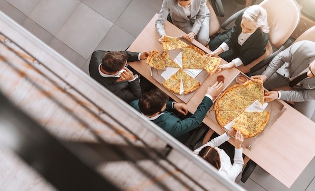 top view business people formal wear eating pizza together place work success work starts by adopting positive attitude 232070 9063