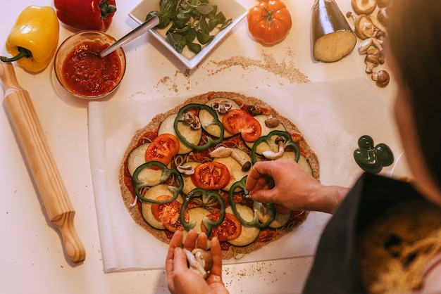 woman adding healthy ingredients pizza home made concept 211139 761